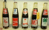 FIVE COMMEMORATIVE COKE BOTTLES