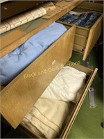 Three drawers of assorted bed linens