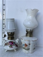 2 small white oil lamps