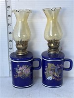 2 small blue oil lamps