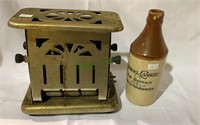 Antique toaster and a antique pottery beer