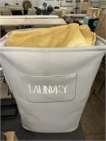 GREY LAUNDRY BASKET WITH DRAPES AND LINENS