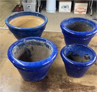 Set of four blue pottery flower pots