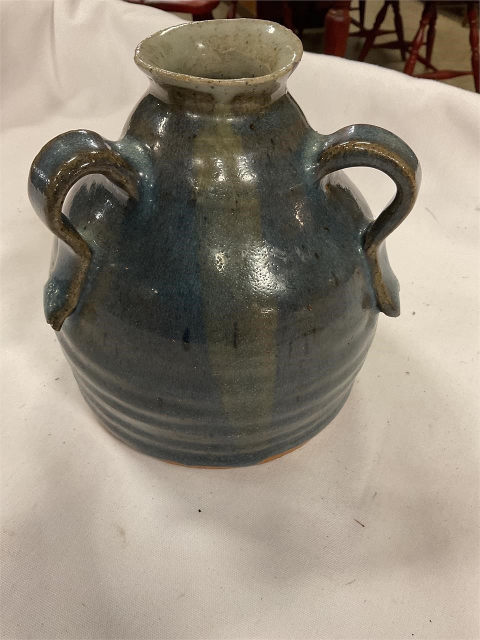 Three handled pottery jug