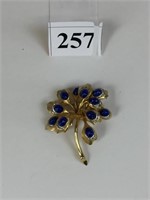 BOUCHER GOLD TONE FLOWER PIN WITH BLUE STONES