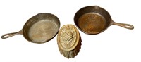 (2) cast iron fry pans & pineapple mold - one