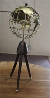 Brass globe on wood tripod base,
