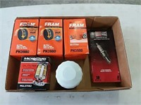 assortment of oil filters and spark plugs