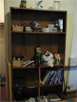 Bookshelf with misc hunting, fishing items