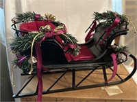 Black metal and red upholstered sleigh.