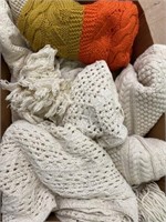 Three white knitted blankets and a colorful