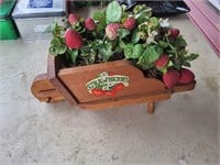Small wooden wheel barrow with strawberries