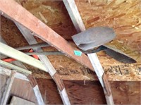 Two shovels up in garden shed rafters