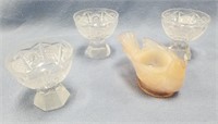 3 crystal shot glasses and a glass candle stick