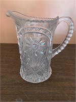 Vintage water pitcher with flowers on the side