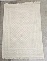 TAN AREA RUG WITH FRINGE - 7'9" X 5'6"