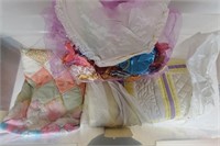 Tote of quilts and ribbons.