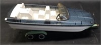 Vintage plastic toy boat with metal trailer