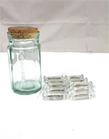 Ten glass knife rests and 7.5" storage jar with