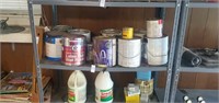Shelf of assorted paints and stains