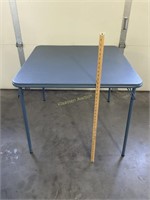 28" tall Meco card table with blue top. Has a f