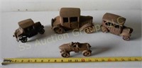 Four cast iron toy cars