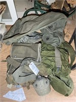 Group of army style book bags and duffel bags