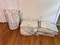 Four garment bags & laundry basket