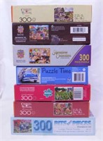 Seven 300 piece jigsaw puzzles