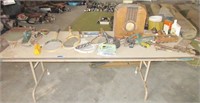 Table full of misc. items, old radio, tennis racke