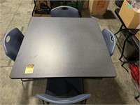 Break room table with four heavy duty chairs.