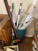 Green garbage can and contents, brooms, swiffer