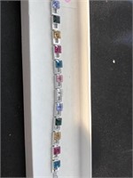 Unusual tennis bracelet with faceted stones of