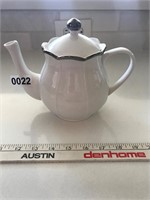 White ceramic teapot with silver paint accents