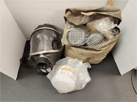 Vintage gas mask and bag of new filters