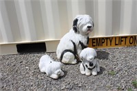 Three plaster dogs, coin banks, one has damage,