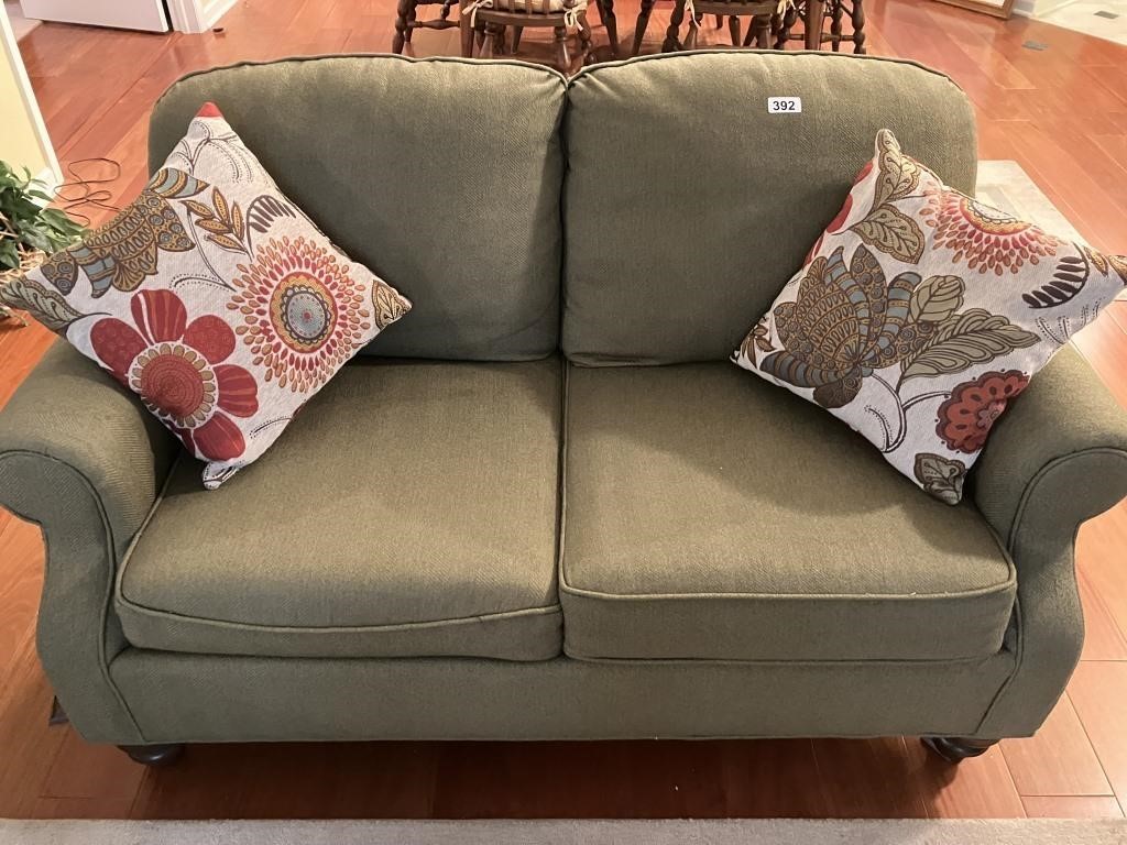 Green upholstered 2-person loveseat