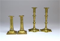 Two pairs of antique English brass candlesticks