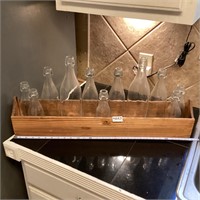 Wood box with assorted size glass bottles