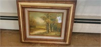 Trees by river framed painting