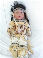 Porcelain native American doll. 15" sitting down.