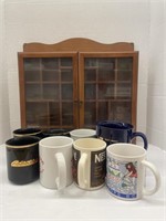 Assortment of coffee mugs and a wooden display