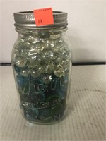 Kerr quart jar full of vase filler marbles.