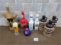 Vintage alcohol bottles (one coverd in corque)