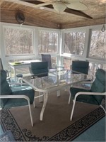 Glass patio table with four metal chairs with