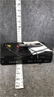 vhs/dvd player with remote and paperwork