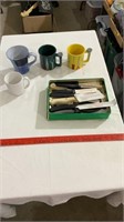 coffee mugs, assorted kitchen knives.