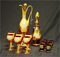 Two Italian hand painted ruby glass liqueur sets