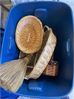 Blue tote with lid filled with baskets and broom