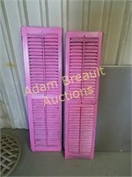 Two wooden 11 x 44 painted shutters